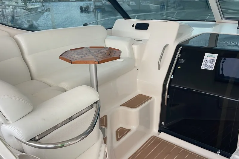 Slide: The Image of 2009 Tiara Yachts 3900 Sovran interior with white seating and wooden table. - 19