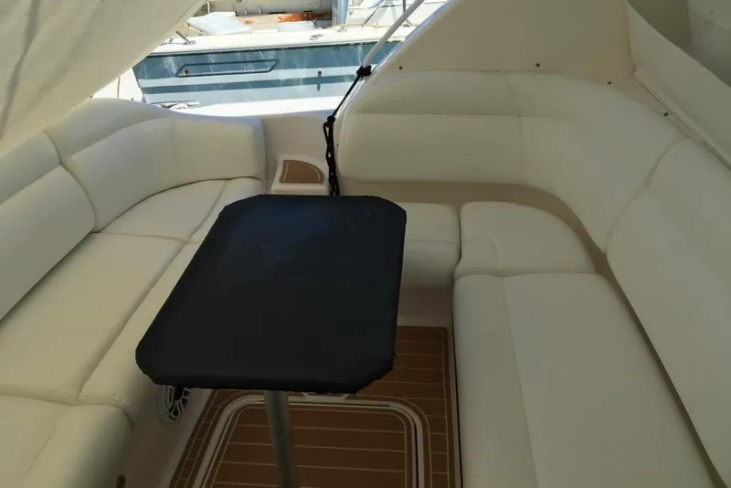 Slide: The Image of 2009 Tiara Yachts 3900 Sovran interior with white seating and a central table. - 14