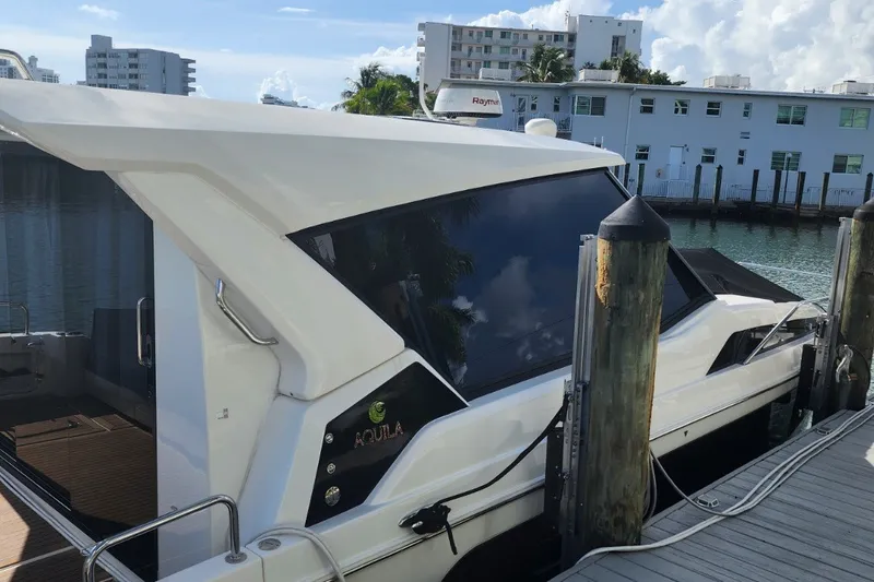 Slide: The Image of 2024 Aquila 36 Sport yacht docked at marina, showcasing sleek design and modern features. - 19