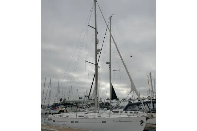 Slide: The Image of Sailing yacht Beneteau 411, 1999 model, docked at marina under cloudy skies. - 81