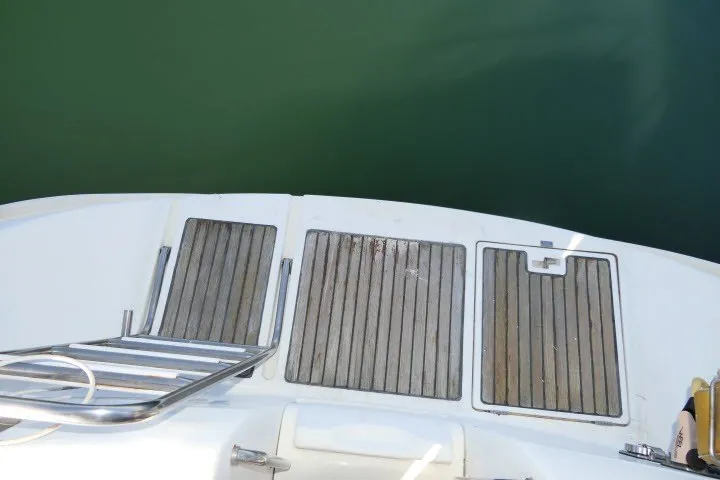 Slide: The Image of Stern view of 1999 Beneteau 411 yacht with wooden deck and swim ladder. - 57