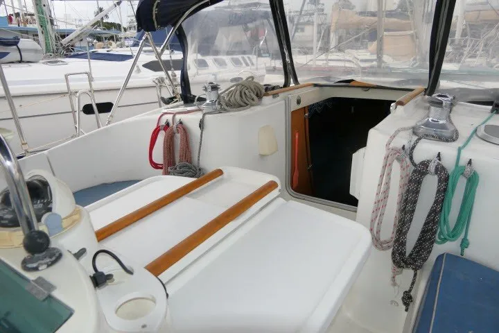 Slide: The Image of Cockpit of a 1999 Beneteau 411 sailboat with ropes and winches. - 54