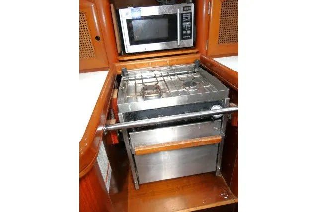 Slide: The Image of Galley kitchen in 1999 Beneteau 411 yacht with stove and microwave. - 16