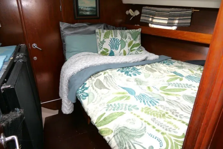 Slide: The Image of Cozy cabin interior of a 1999 Beneteau 411 sailboat with floral bedding. - 34