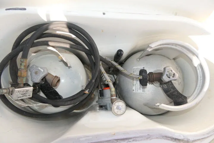 Slide: The Image of Two propane tanks with hoses in a Beneteau 411 sailboat, 1999 model. - 56