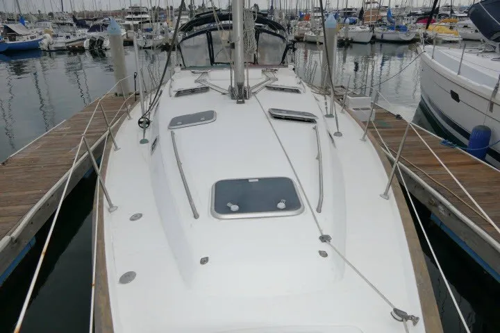 Slide: The Image of 1999 Beneteau 411 sailboat docked at marina, showcasing deck and rigging. - 63