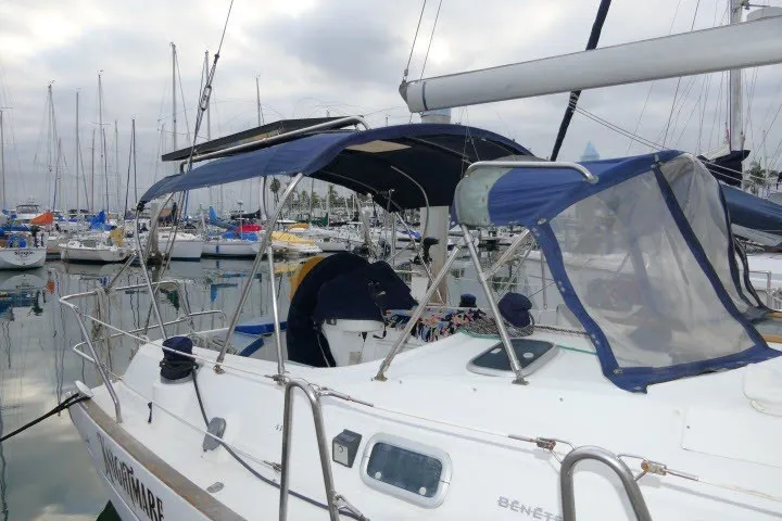 Slide: The Image of Sailboat Beneteau 411, 1999 model, docked in a marina with overcast skies. - 59