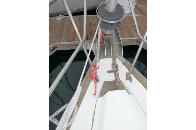 Slide: The Image of Bow of a 1999 Beneteau 411 sailboat docked, featuring ropes and deck details. - 61