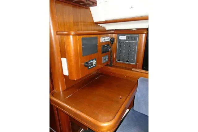 Slide: The Image of Navigation station of 1999 Beneteau 411 yacht with wooden finish and control panels. - 20