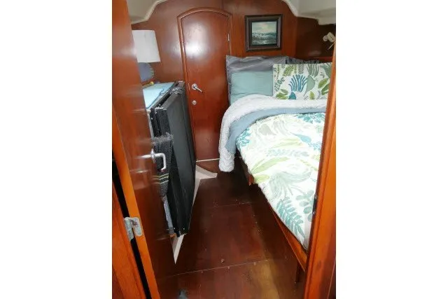 Slide: The Image of Cozy cabin interior of a 1999 Beneteau 411 sailboat with wooden furnishings. - 32