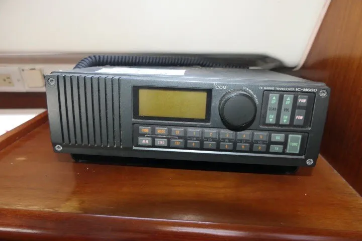 Slide: The Image of Marine transceiver IC-M600 on 1999 Beneteau 411 yacht, displayed on wooden surface. - 23