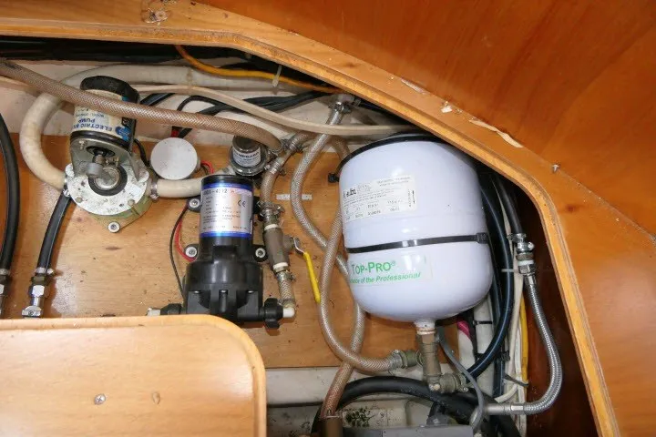 Slide: The Image of Engine compartment of a 1999 Beneteau 411 sailboat, showcasing mechanical components and wiring. - 74