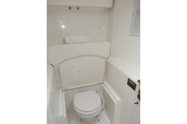 Slide: The Image of 1999 Beneteau 411 yacht bathroom with white marine toilet and compact design. - 38
