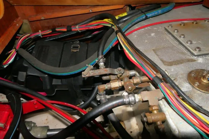 Slide: The Image of Engine compartment of a 1999 Beneteau 411 sailboat with colorful wiring and components. - 70