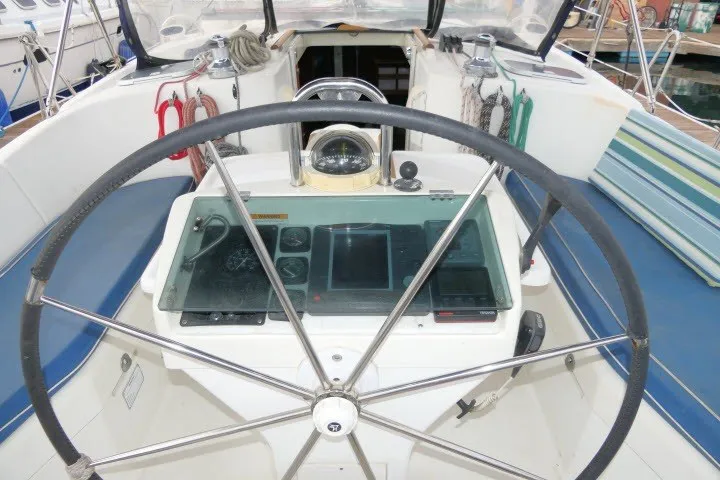 Slide: The Image of Cockpit of 1999 Beneteau 411 sailboat with steering wheel and navigation instruments. - 50
