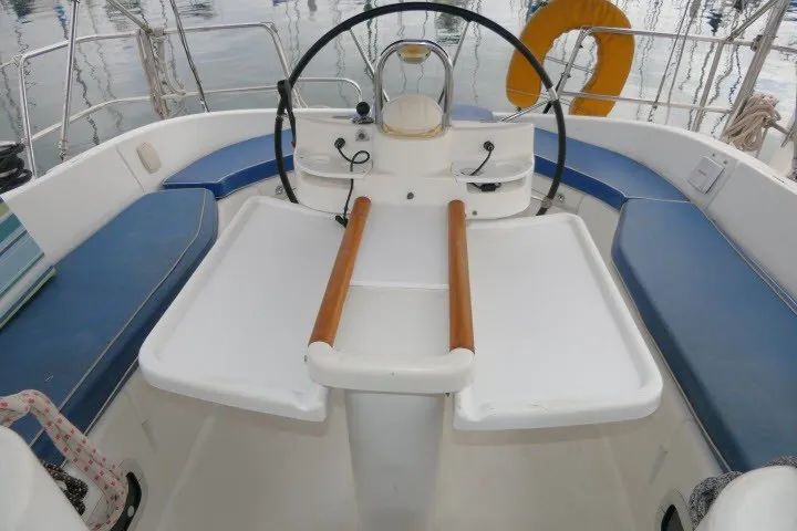 Slide: The Image of Cockpit of 1999 Beneteau 411 sailboat with steering wheel and seating. - 43