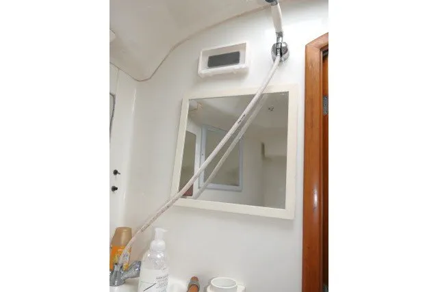 Slide: The Image of Bathroom interior of 1999 Beneteau 411 yacht with mirror and showerhead. - 41