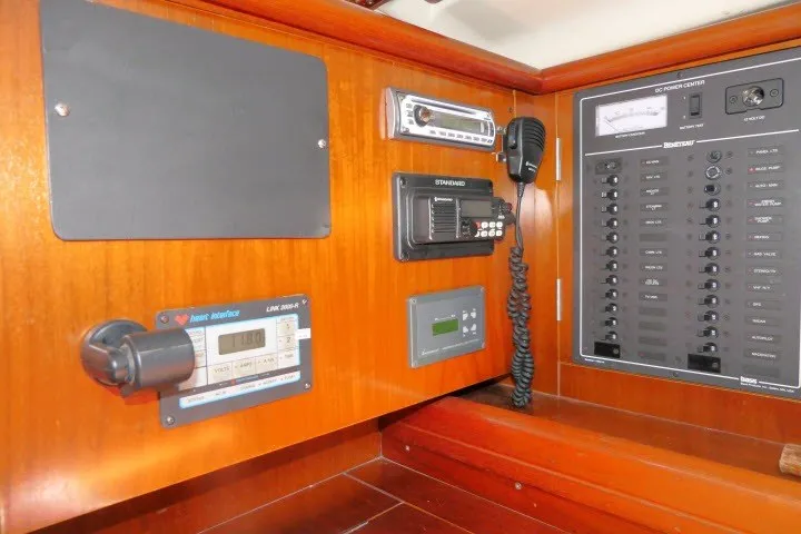 Slide: The Image of Control panel of a 1999 Beneteau 411 sailboat with navigation and communication equipment. - 21