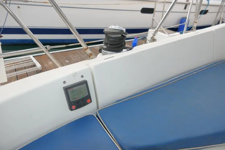 Slide: The Image of Cockpit of 1999 Beneteau 411 sailboat with blue cushions and navigation equipment. - 45