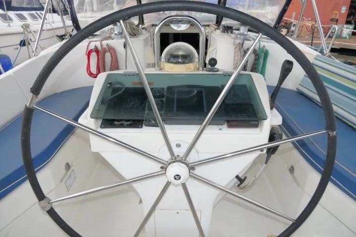 Slide: The Image of Steering wheel of a 1999 Beneteau 411 sailboat, featuring navigation instruments. - 51