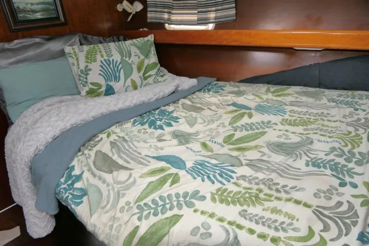 Slide: The Image of Cozy cabin interior of 1999 Beneteau 411 with floral bedding and wooden accents. - 35
