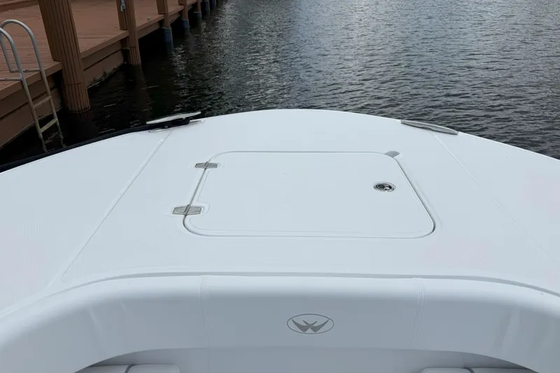 Slide: The Image of 2026 Southport 30 FE boat bow view at dockside, featuring sleek design. - 18