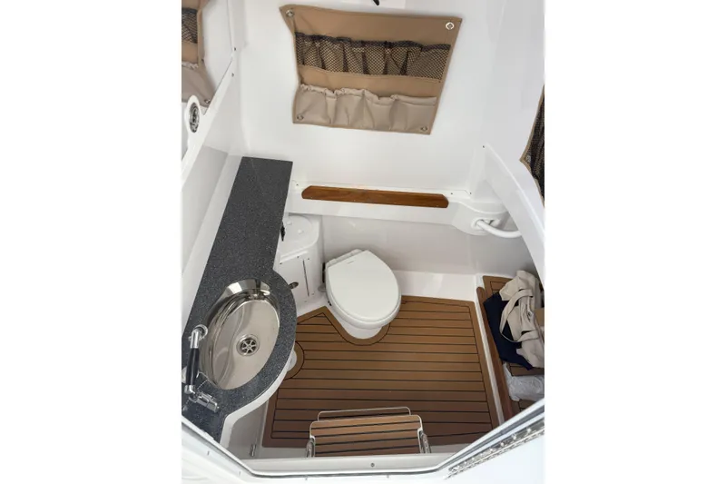 Slide: The Image of 2026 Southport 30 FE boat interior with sink, toilet, and wooden flooring. - 22