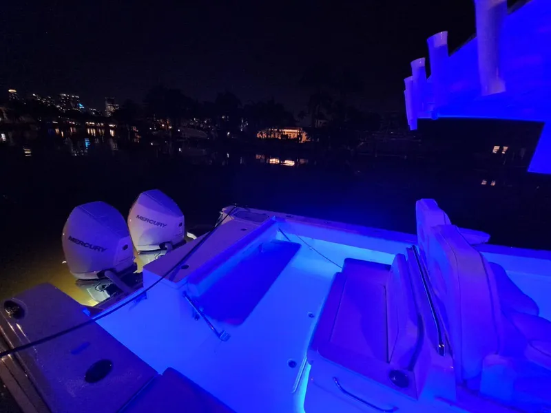Slide: The Image of 2024 Southport 30 FE boat with blue LED lights at night. - 30