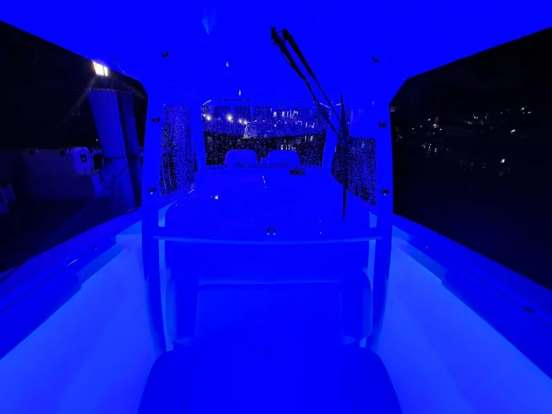 Slide: The Image of 2024 Southport 30 FE boat interior illuminated with blue LED lights at night. - 31