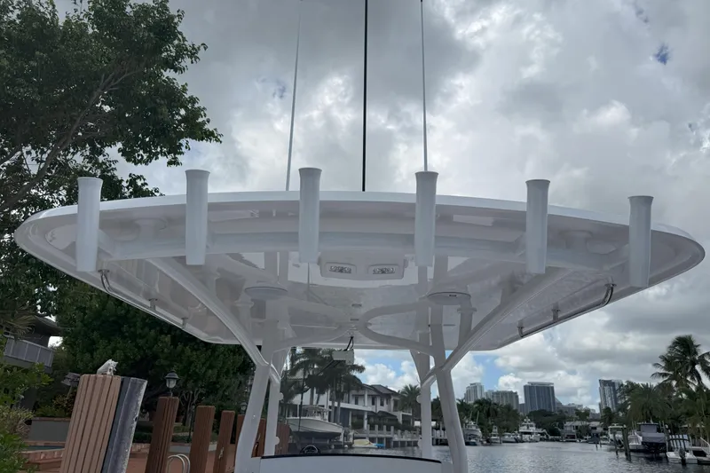 Slide: The Image of 2026 Southport 30 FE boat with rod holders, docked under cloudy sky. - 26