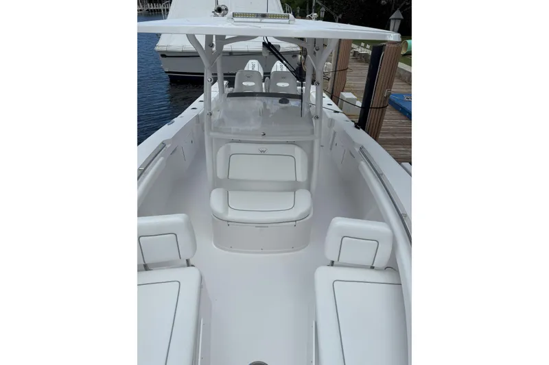 Slide: The Image of 2026 Southport 30 FE boat interior with white seating and helm station. - 21