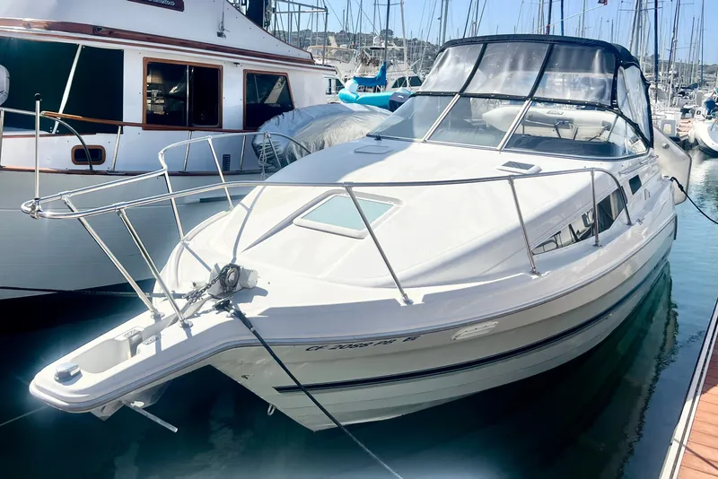 The Image of 1997 Bayliner 2855 Ciera boat docked in a marina, featuring sleek design and spacious cabin. - 0