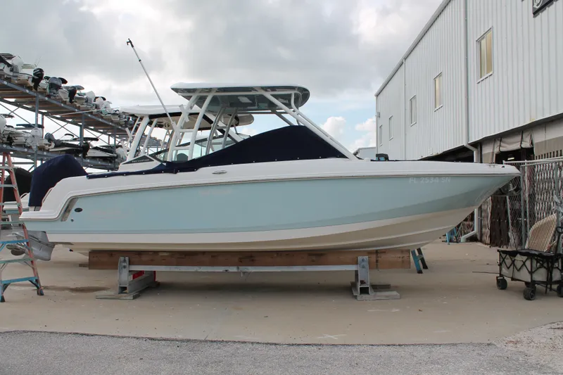 The Image of 2020 Boston Whaler 230 Vantage boat on dry dock, side view. - 0