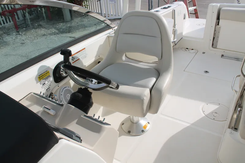 Slide: The Image of 2020 Boston Whaler 230 Vantage helm with steering wheel and comfortable captain's chair. - 10