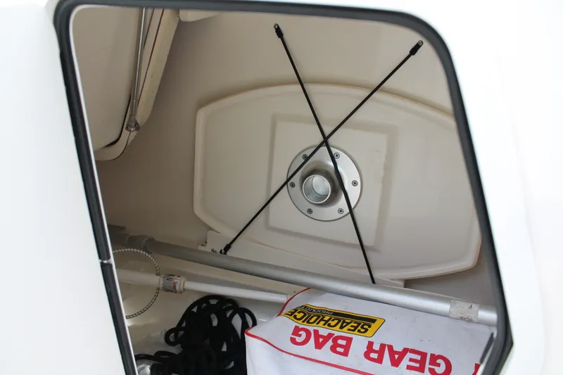 Slide: The Image of Storage compartment of 2020 Boston Whaler 230 Vantage with gear bag and equipment. - 14