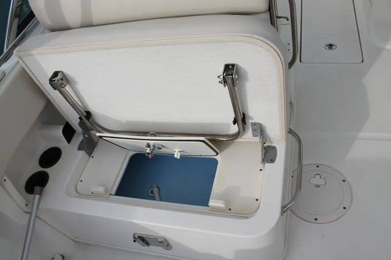 Slide: The Image of 2020 Boston Whaler 230 Vantage boat seat with open storage compartment. - 13