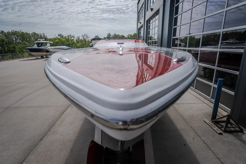 Slide: The Image of 2005 Donzi 35 ZR speedboat with sleek red and white design, parked outdoors. - 44