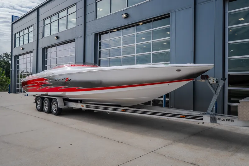 Slide: The Image of 2005 Donzi 35 ZR speedboat on trailer, parked outside modern building. - 54