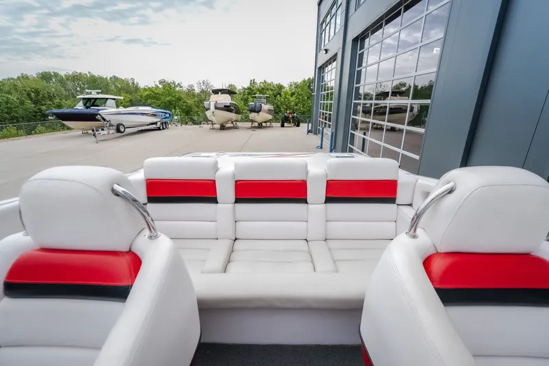 Slide: The Image of Interior of 2005 Donzi 35 ZR boat with white and red seating, docked near other boats. - 40
