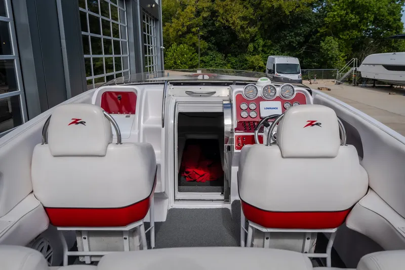 Slide: The Image of 2005 Donzi 35 ZR boat interior with white and red seating, dashboard, and controls. - 19