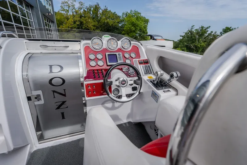 Slide: The Image of Cockpit of a 2005 Donzi 35 ZR boat with red dashboard and steering wheel. - 23