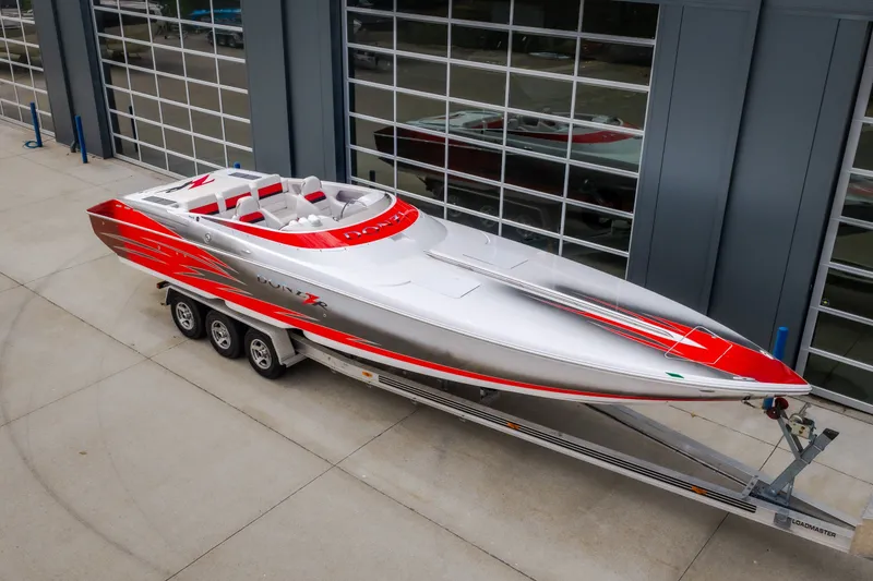 Slide: The Image of 2005 Donzi 35 ZR speedboat with red and silver design on a trailer. - 4