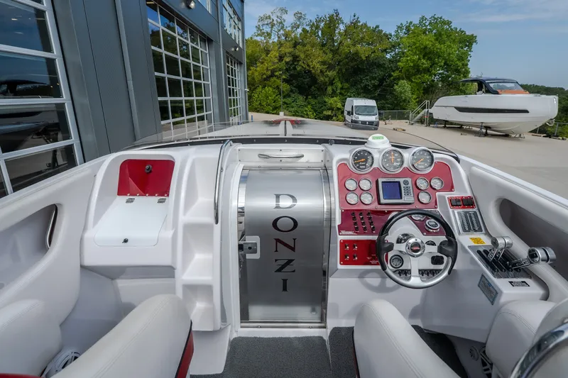Slide: The Image of 2005 Donzi 35 ZR boat cockpit with sleek dashboard and steering wheel. - 21