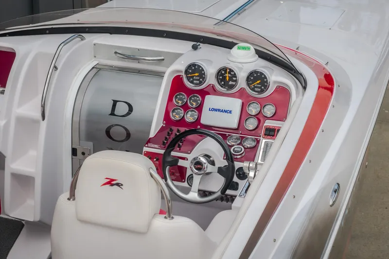 Slide: The Image of Cockpit of 2005 Donzi 35 ZR boat with red dashboard and steering wheel. - 11