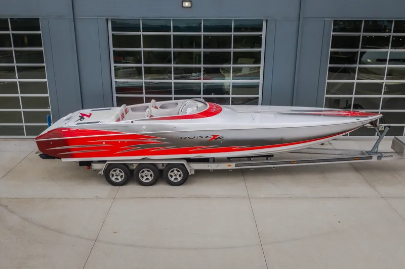 Slide: The Image of 2005 Donzi 35 ZR speedboat with red and silver design on a trailer. - 52