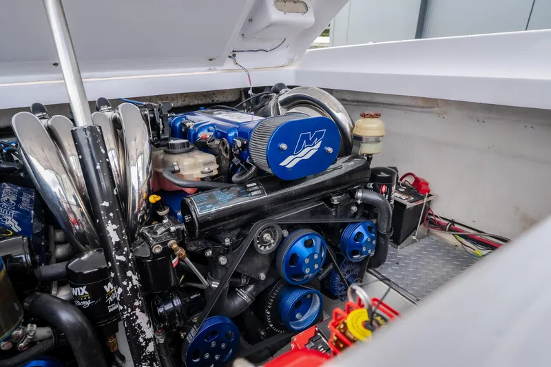 Slide: The Image of Engine compartment of a 2005 Donzi 35 ZR boat, featuring a powerful marine engine. - 35