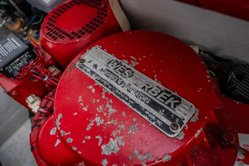 Slide: The Image of Red Westerbeke engine in a 2005 Donzi 35 ZR boat, showing wear and label details. - 50