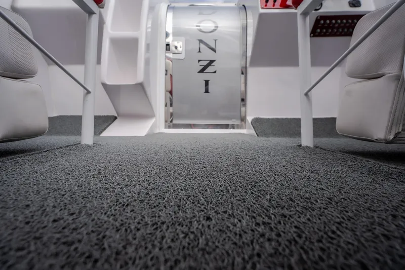 Slide: The Image of Interior view of a 2005 Donzi 35 ZR boat, featuring carpeted flooring and sleek design. - 42