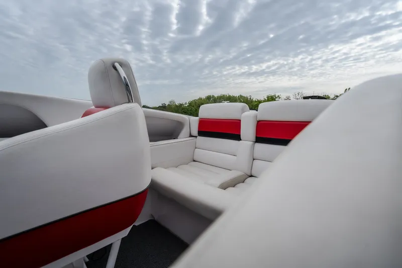 Slide: The Image of Interior of 2005 Donzi 35 ZR boat with white and red seating under cloudy sky. - 31
