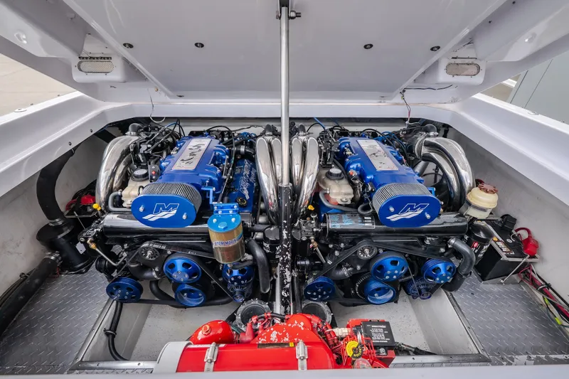 Slide: The Image of Twin engines in a 2005 Donzi 35 ZR boat, showcasing powerful marine performance. - 34